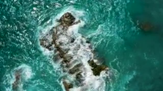 EL CARDONCITO BCS MEXICO-2020: Blue Ocean Water Swirls And Breaks On Mossy Rock