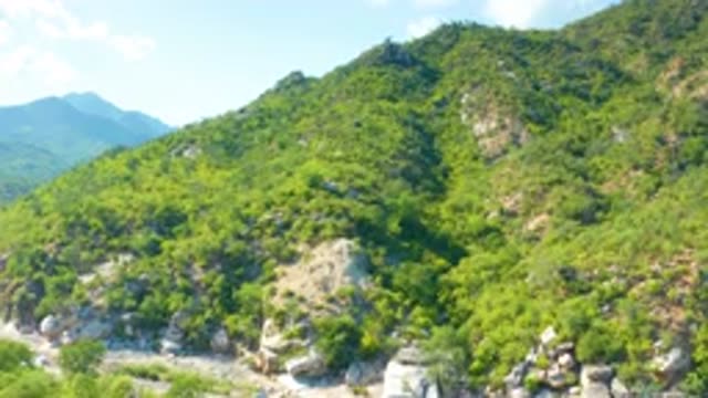 LA PALMA BCS MEXICO-2020: Greenery Grows Upon Large Mountains Sitting Against Blue Sky