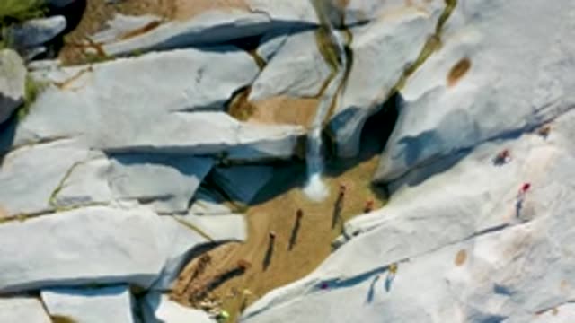 LA PALMA BCS MEXICO-2020: An Aerial View Of A Waterfall And Beings Walking On A Rocky Trail