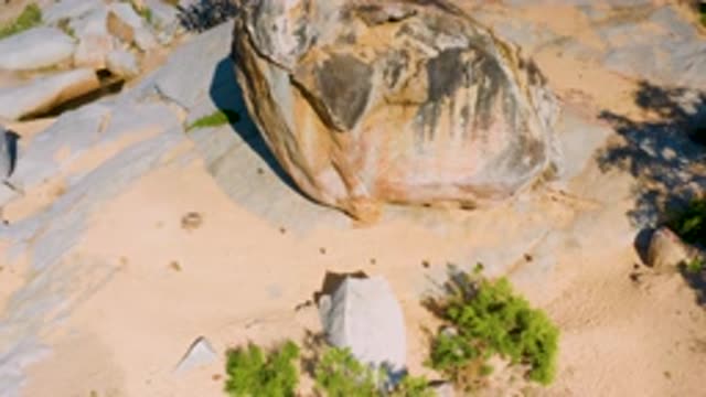 LA PALMA BCS MEXICO-2020: Drone Footage Panning Up On Rock In Sandy Environment