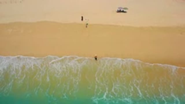 DESERT PARK NATURAL RESERVE BAJA CALIFORNIA SUR MEXICO-2020: Aerial View of Surfer in Shallow Turquoise Waves
