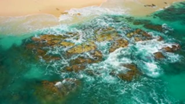 DESERT PARK NATURAL RESERVE BAJA CALIFORNIA SUR MEXICO-2020: Aerial View Of Turquoise Waves Crashing On Rocky Shore