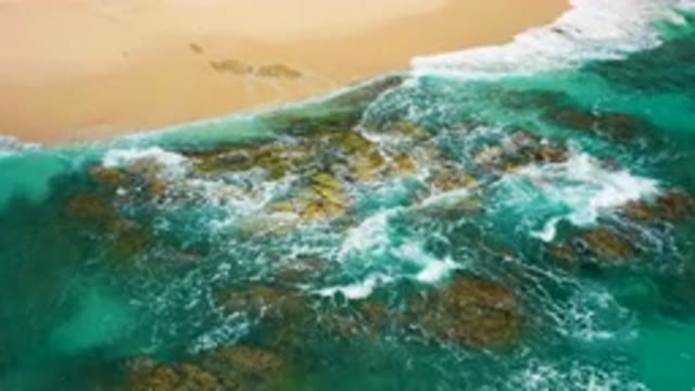 DESERT PARK NATURAL RESERVE BAJA CALIFORNIA SUR MEXICO-2020: Aerial View Of Turquoise Waves Crashing On Rocky Beach