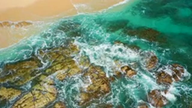 DESERT PARK NATURAL RESERVE BAJA CALIFORNIA SUR MEXICO-2020: Aerial View Of Turquoise Waves Crashing On Rocky Shore