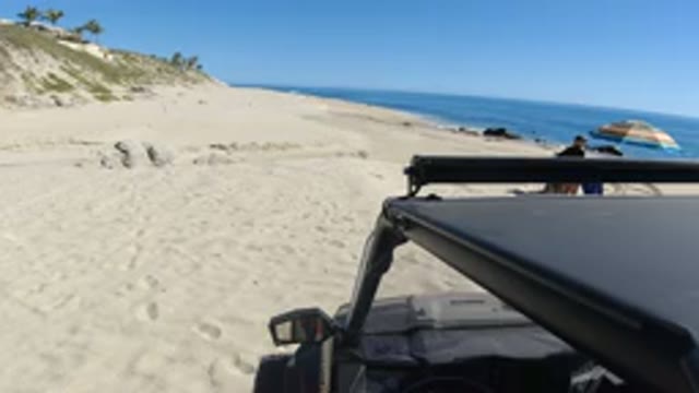 LOS CABOS MEXICO-2019: Footprints In The Sand Show Two People Walking While The